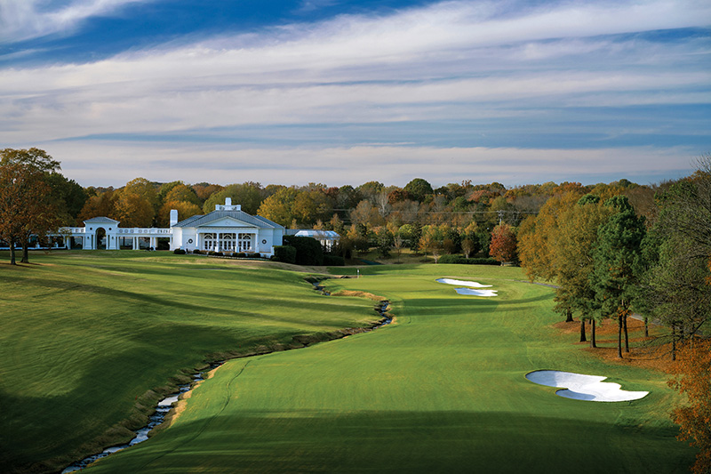 Championship artwork with Carolina blue accents and sweeping fairway contours.